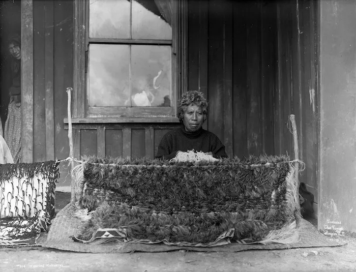 Putiputi Tonihi weaving a cloak with kiwi feathers