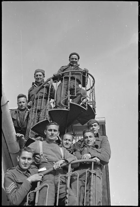 Kiwi soldiers on a spiral staircase at the house in which they are billetted in Italy, World War II - Photograph taken by George Kaye