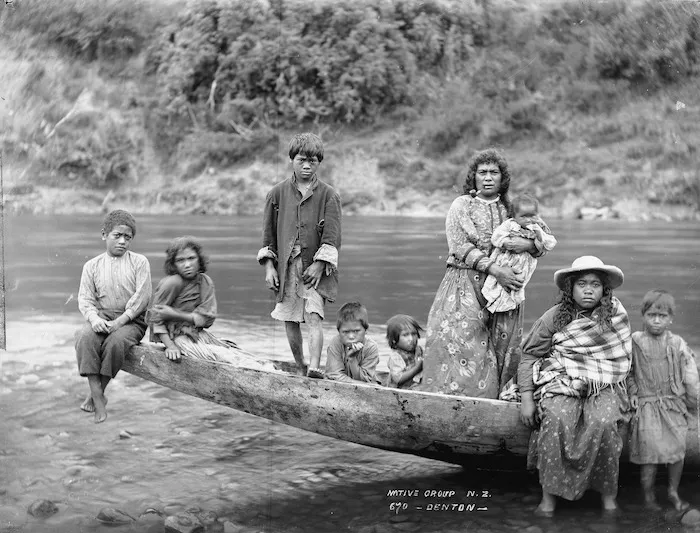 Unidentified group sitting on the prow of a canoe