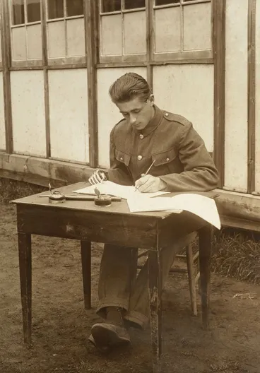 Image: Unidentified WWI soldier with a prosthetic right hand learning to write with his left hand at Oatlands Park, Surrey, England