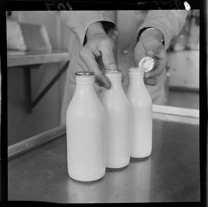 Checking the seal on new bottles, Wellington city milk department