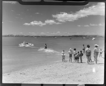 Image: People watching a water skier at Maraetai beach, Auckland