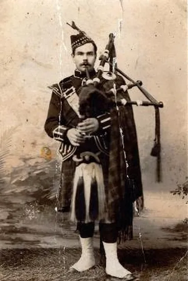 Image: Walter Sutherland playing bagpipes in a photographic studio