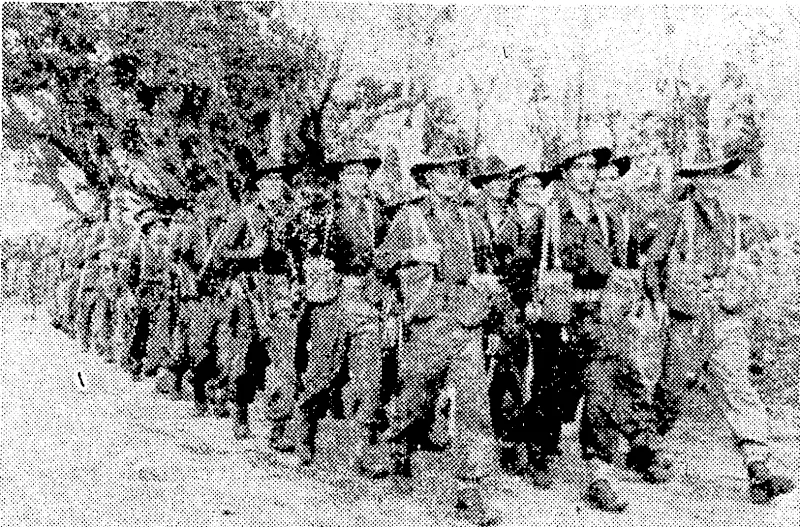 Members of the 6th Australian Division marching to the beach-head to join warships for the amphibious assault on the JVetvak Peninsula which resulted in the annihilation of the Japanese. (Evening Post, 26 May 1945)