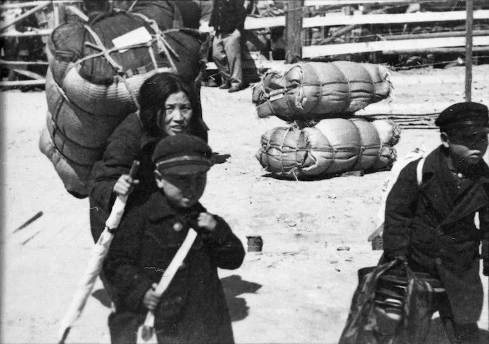 Korean children carrying their belongings