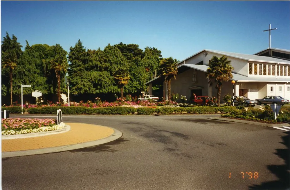 Main Street; roundabout at Pine Avenue, showing St Joseph's church.