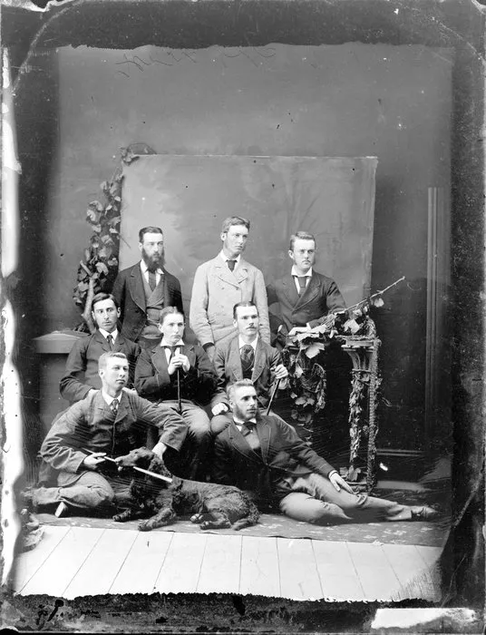 Group of unidentified young men with a dog and walking sticks