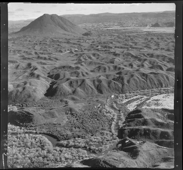 Image: Mt Edgecumbe, Whakatane District, Bay of Plenty, showing view across stream and open foot hills to mountain, with possibly Kawerau and sawmill in distance