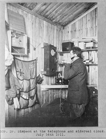 Image: George Simpson on the telephone, timing the occultation of Jupiter during the British Antarctic Expedition of 1911-1913