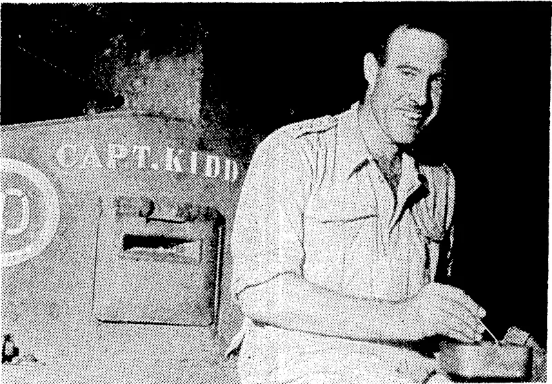 Captain N. G. Whitehead of the Australian-manned mechanised infantry in Neiv Guinea, ivho are using General Stuart tanks. Captain Whitehead, seated on his tank, "Captain Kidd," was about to lead an attack on the Japanese at Buna. Many of the tanks in use have names of a similar type, one being called "Captain Blood," and another "Captain. Gore" (Evening Post, 11 January 1943)