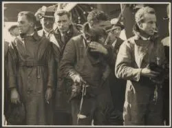 Portrait of H.A. Litchfield, T.H. McWilliam, Charles Ulm and Charles Kingsford Smith, with well-wishers on arrival at Christchurch, New Zealand, 11 September 1928 / Weekly Press