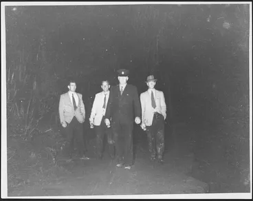 Image: Police officer and search volunteers at the scene of the railway disaster at Tangiwai