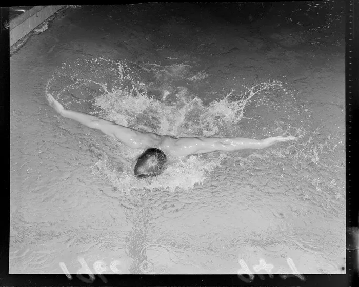 Swimmer Peter Hatch demonstrates 'butterfly stroke' swimming, [Freyberg Swimming Pool, Wellington City?]