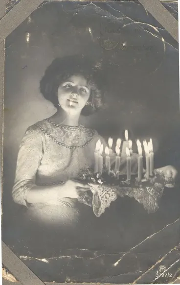 Image: Young woman with birthday cake. c1914-18.