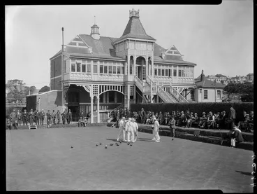 Image: Bowls club building, men playing lawn bowls and spectators