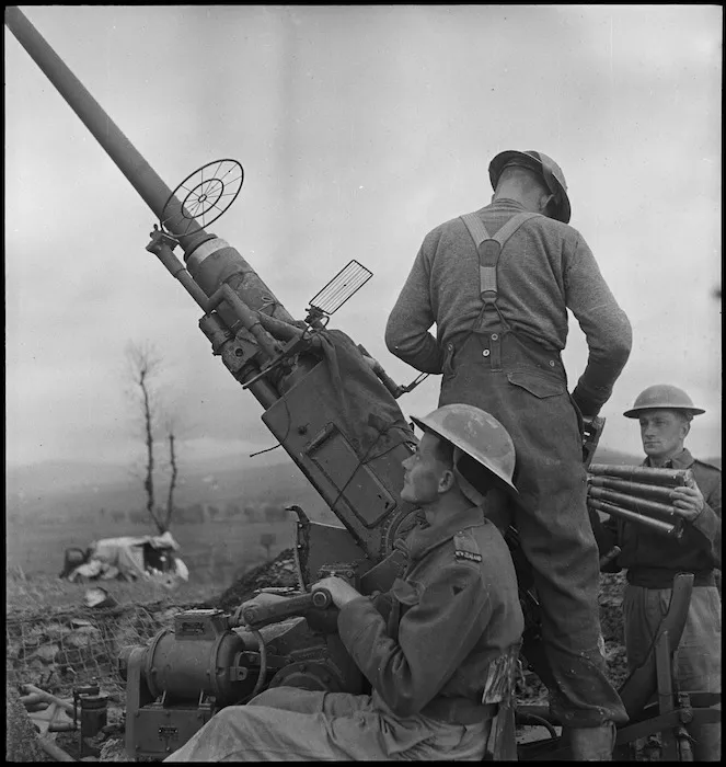 F A Thompson at action station on a NZ anti aircraft gun in Italy, World War II - Photograph taken by George Kaye