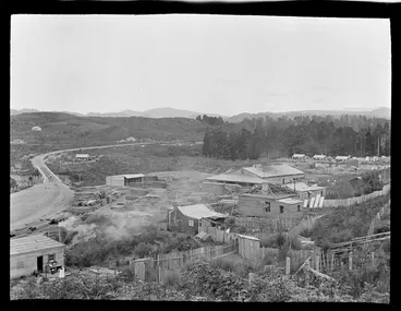 Image: The settlement of Kakahi with sawmill and stacked lumber next to the railway line and rail bridge, Manawatu-Whanganui Region