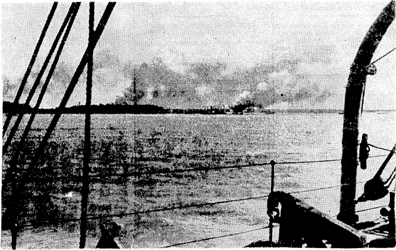 An, Allied ship sel on fire in the course, of a Japanese air raid on Darwin (Evening Post, 18 August 1942)