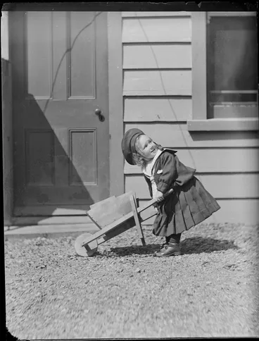 Image: Portrait of a young Edgar Williams with a toy wooden wheelbarrow in front of the family house, 'View Bank', Maitland Street, Dunedin, Otago Region