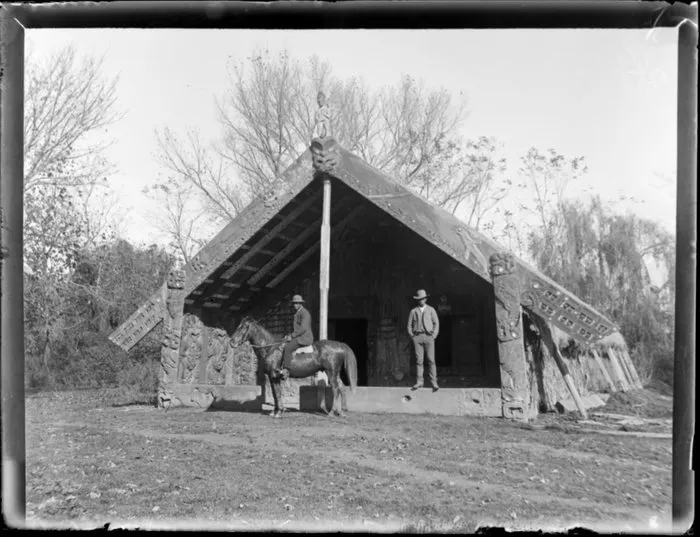 Two men outside Te Mana o Tūranga wharenui, Whakatō Marae, Manutūkē