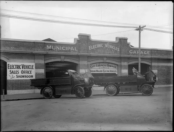 Two electric trucks outside the Municipal Electric Vehicles Garage, Christchurch