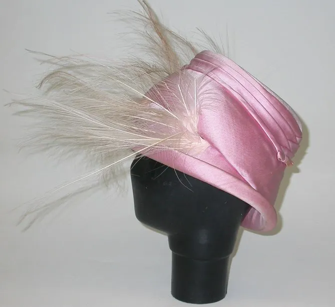 Pink cloche hat with osprey feather trim