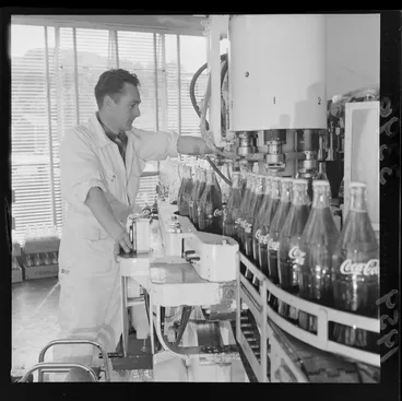 Image: Unidentified man processing bottles at a Coca Cola factory, Lower Hutt, Wellington