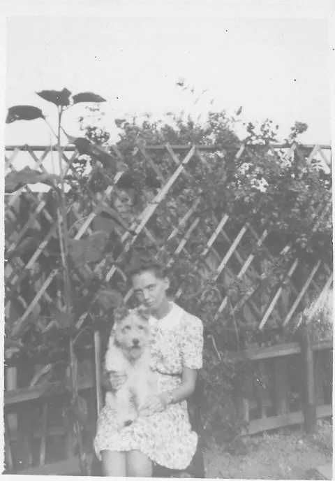 Lady in flowered dress with dog.