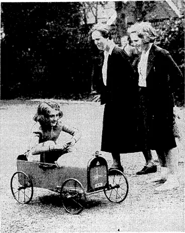 Image: Mrs. Eyston, wife of Captain G. E. T. Eyston, the famous speed motorist, with her eldest daughter Magdalen, watching her younger daughter Betty experiment with a toy motor-car when they were on a holiday visit to the Sussex coast early this month. (Evening Post, 21 September 1938)