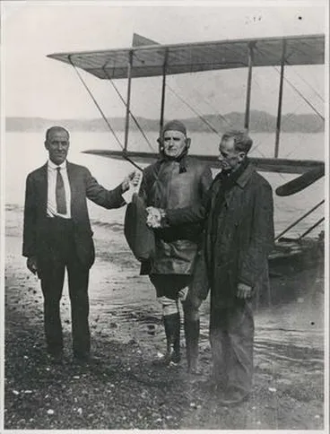 Russell Post-Master receiving 1st air-mail bag from Pilot George Bolt, Walsh Bros.Flying School,Mission Bay. Image: Russell Post-Master receiving 1st air-mail bag from Pilot George Bolt, Walsh Bros.Flying School,Mission Bay.
