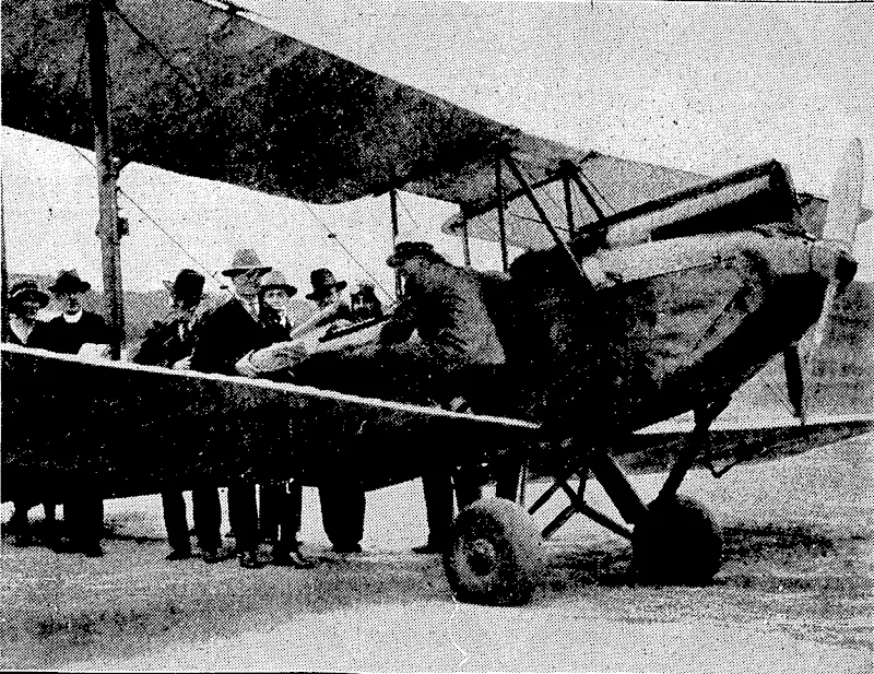 Evening Post" Photo. TO AID IN ORGANISING A CHARITY • FLIGHT.-TAc Mayor's Relief of > Distress -Fwid^tlie Smith Family, the Cdy .Mission, and the PlunketSociety are all'interested in the special charity flight to* be given by. Sir Charles Kings ford Smith. Yesterday Mr. A. W. Nisbet, secretary., of the Wellington Aero Club;JejssZmeroplane:tocarry\qut_ somepj'-the' advance work.of the.scheme. .' (Evening Post, 05 January 1933)