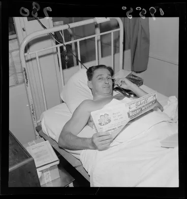 Image: Mr Dick Burke in a hospital bed, reading Rugby Weekly magazine