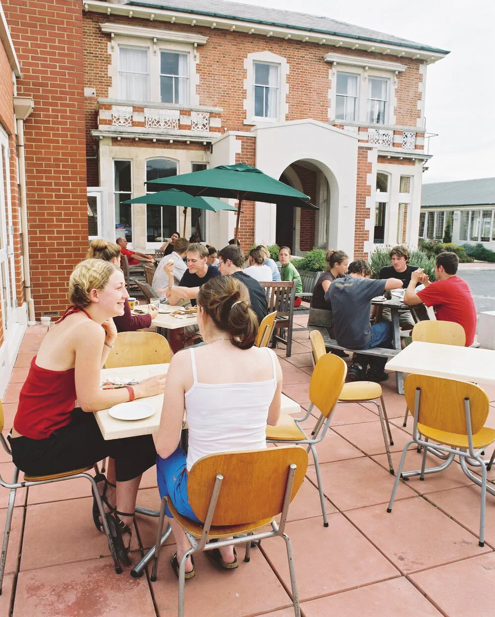 Residents seated at outdoor tables, Arana Hall