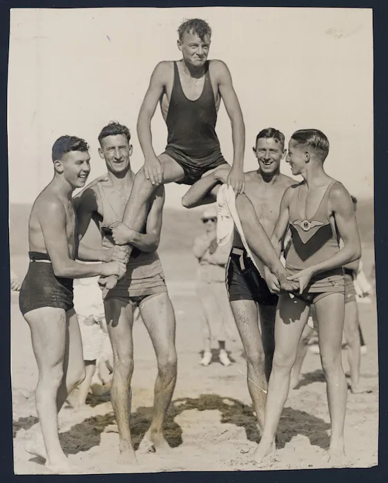 Mr J Clark of Maranui Life Saving Club being carried by clubmates, Lyall Bay