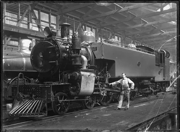 Image: Albert Percy Godber standing beside a Wab class locomotive, NZR number 686, in the Petone Railway Workshops.