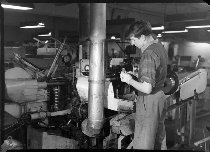 Man operating machine in battery factory
