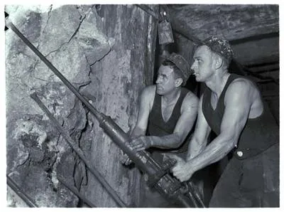 Waihi - Two miners work inside mine.