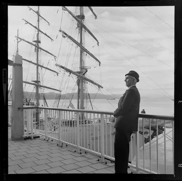 Image: Unidentified man in front of sailing ship ARC Gloria, berthed at overseas terminal, Wellington Harbour