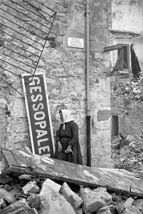 A woman among the ruins of Gessopalena, Italy