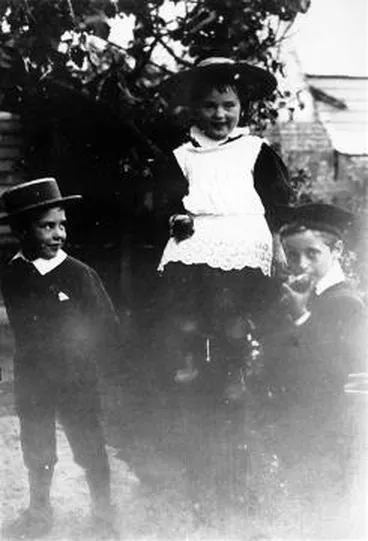 Image: Three children eating apples in the garden