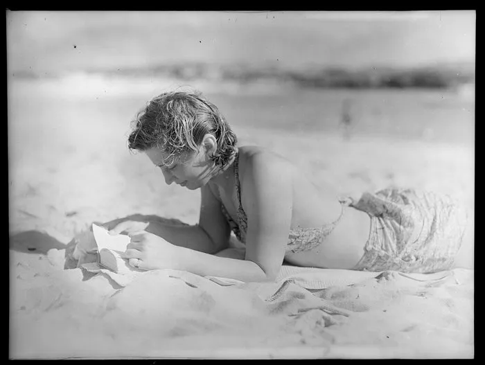 Unidentified woman reading on the beach, Norfolk Island
