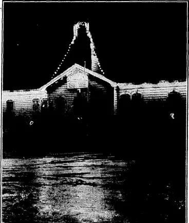 Image: Evening PoMt" fooio. NEWTOWN SCHOOL JUBILEE.—The jubilee celebrations of the Newtown School commence this week with a whole holiday for the children tomorrow. The,school building has been decorated with coloured lights, this photograph being taken last night when they were first iurned on. (Evening Post, 27 September 1934)