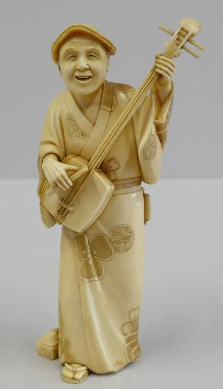 Okimono: Nagashi [Street Musician]; Man Playing a Stringed Instrument.