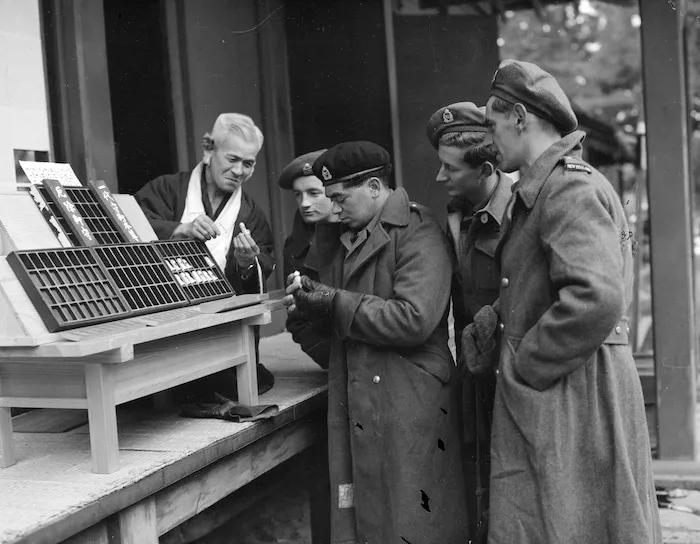 NZEF in Japan - New Zealanders, on leave at Nikko, purchase good luck charm from Shinto priest during a sight seeing visit to the famous Japanese shrines