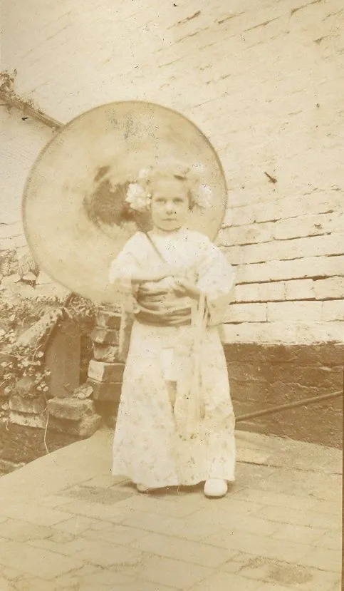 Young girl dressed in Japanese kimono with parasol