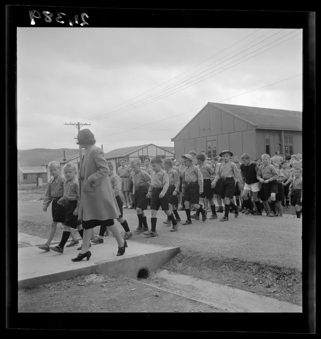 Mrs Krystyna Skwarko leads a group of children to a dining room at a Polish refugee camp, Pahiatua