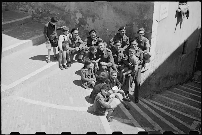 Front line troops on leave at Campobasso, Italy, talk with local children - Photograph taken by George Bull