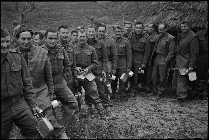 Gunners of New Zealand Artillery formation line up for Christmas dinner on the Italian Front line, World War II - Photograph taken by George Kaye
