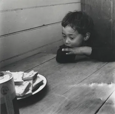 Image: Jimmy can hardly wait for the thick slices of the bread... From the series: Washday at the pa
