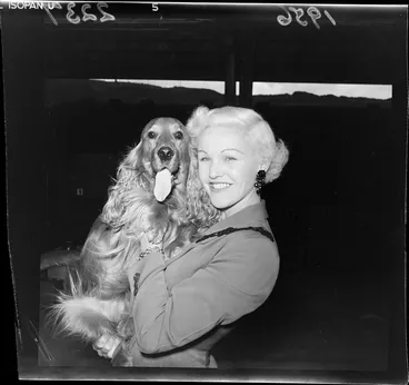 Image: Barbara Howe, ice-skater, with a golden spaniel